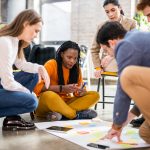 Project managers and employees brainstorming on ideas - Multi-ethnic group of workers having business meeting in a start-up office